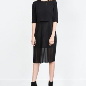 Black dress with pleats.